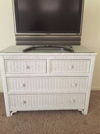 Matching vintage wicker dresser has a matching nightstand and headboard.  Sharp Flatscreen TV has a remote and all manuals