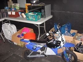 Kid's Razor with helmet, takes a charge, back tire needs new tube.  