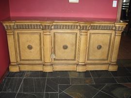 Large Scale Buffet, matches Dining table/chairs.  Buffet measures 85 inches wide, 38 inches tall, 22 inches deep.  Has granite top and pull-out top drawer in middle and right panels.  Shelves in all three panels when doors open.  Key opens all three doors for secure storage. 