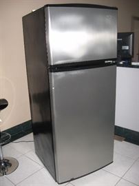 Whirlpool Refrigerator / Freezer, measures:  28.5 inches deep, 28 inches wide, 68 inches high.  Upstairs, will need to be transported down via wide spiral staircase. 