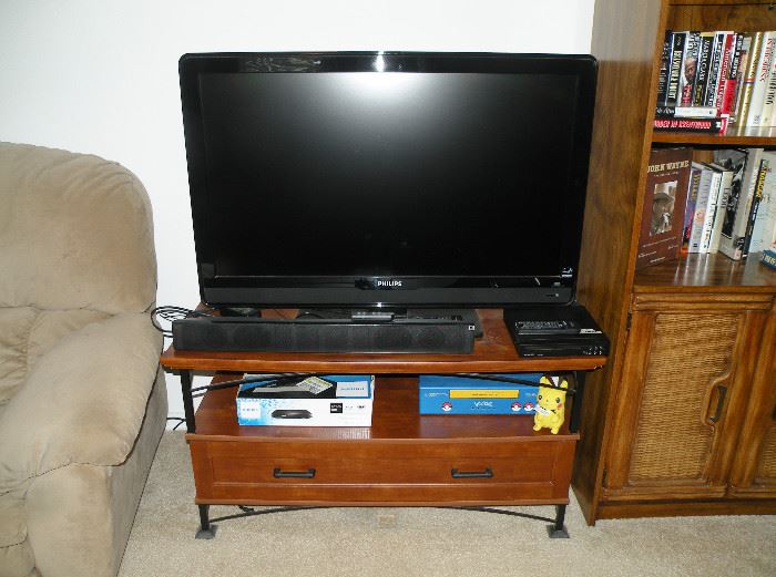 42" Phillips Flat Screen TV. Nice modern big screen TV stand. Sony sound bar. Phillips BDP1200 DVD player. Pokemon Pikachu VCR!