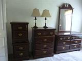 High dresser, low dresser with mirror and two end tables in dark wood