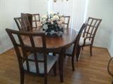 Handsome dining table with six chairs and one leaf