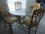 Dressy kitchen/dining table with metal frame seats and base and glass top