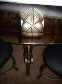 Glass top wrought iron table and four chairs, has black marble look cover
