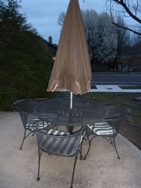 Woodard wrought iron patio table and four chairs with chaise