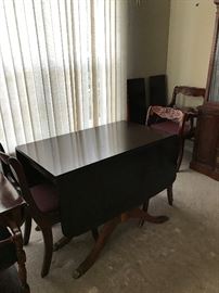 Mahogany drop leaf table comes with three leaves (extends to 7 1/2 feet), 6 chairs (2 captain chairs) and a cover.  Meticulous condition.