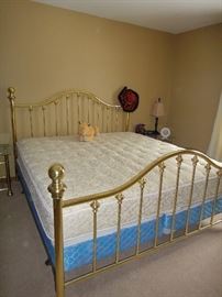 King brass bed and mattresses. Matching glass and brass nightstands 