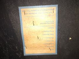 Tag on the bottom of table. 