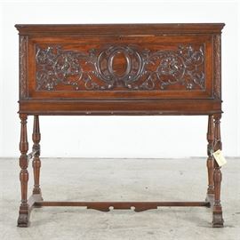 Victorian Gothic Revival Carved Walnut Writing Desk: A Victorian Gothic Revival writing desk in walnut. The front is heavily carved and opens out to reveal a fitted interior with drawers and shelves inside. There is a keyhole escutcheon but no key. The legs are turned with two turned side supports. The bottom sides are connected a by a shaped H stretcher atop scrolled feet.