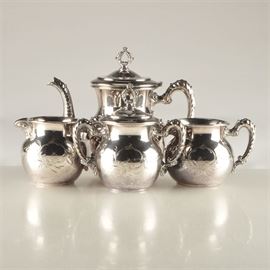 Richfield Plate Co. Quadruple Plate Tea Set: A four piece quadruple plate tea set from Richfield Plate Co. Included is a small teapot, two sugar bowls and a creamer. All are engraved on both sides. The teapot has a hinged lid and one of the sugar bowls has a detachable lid. Items are marked on the base with the company name, quadruple and 2198.