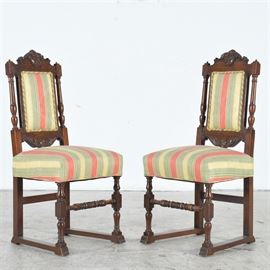 Jacobean Style Side Chairs: A pair of upholstery covered Jacobean side chairs. Labels for upholstery read G. Bitter’s Sons in Louisville, KY. Chairs have turned legs and support in front and squared in back. Side legs are connect at the base by a squared rail. Chair backs have turned posts and upholstery is framed above and below with shell accent carving. Two short finials top each chair post.