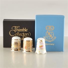 Hand-Painted Ceramic Thimbles from Japan and Germany: A grouping of hand-painted thimbles from Japan and Germany. There are two from Japan, each marked Enzoh, and one from Germany marked Sophienthal. Both are in cushions in original boxes.