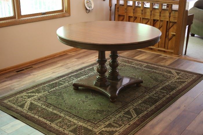 Round pedestal table - seats 4-6 comfortably.  Chairs not available.
