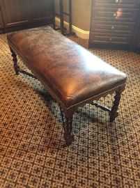 Leather upholstered carved bench