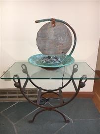 Fountain and glass and wrought iron table
