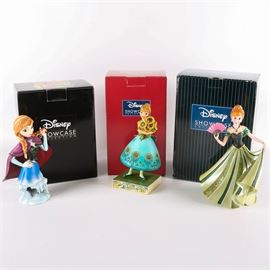 Anna Figurines from Disney's "Frozen": A grouping of three Anna figurines from the popular Disney film Frozen. Featured in this group is Spring In Bloom from Disney Showcase depicting Anna with a bouquet of sunflowers. The set also includes Anna from the Couture de Force collection and Anna from the Grand Jester Studios. Each piece is fashioned from stone resin, stamped to the bottom, and presented in its original box.