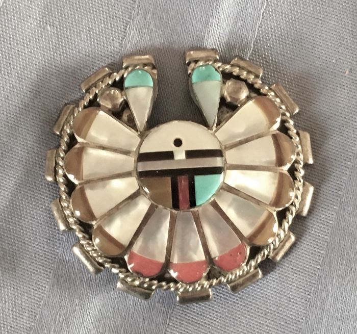 These pieces are made by the Zuni tribe. They are known for their unique designs and amazing artwork. They are made from sterling silver and beautifully inlayed with tones such as Turquoise, Mother of Pearl, Coral, Black Onyx. 
