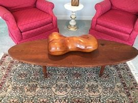 This one sits atop a solid-as-a-rock mcm coffee table. Below is a wonderful antique silk rug.