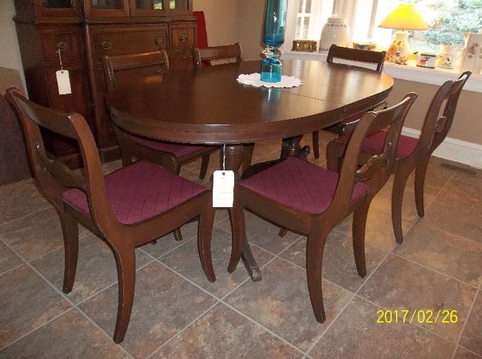 Mahogany table with two leaves, pads, and six chairs