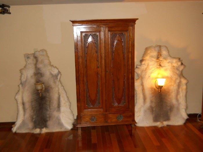 hand carved very ornate wine cabinet     Very Rare full fur of a wolf entire body. It now has sconces lights the fur it should be easy to take off?