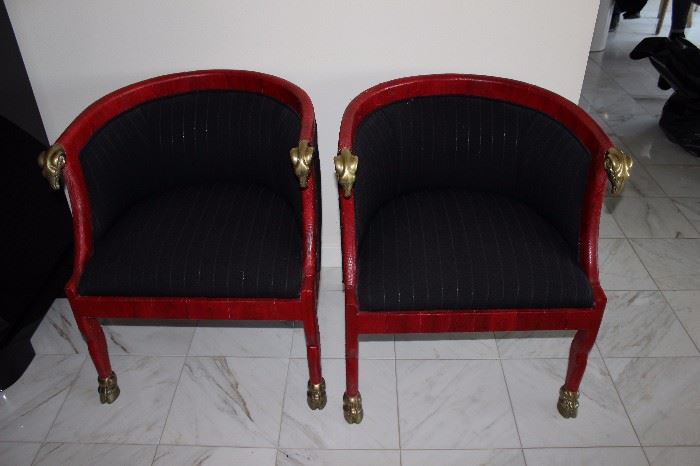 Pair of red goatskin chairs with brass rams heads on arms 