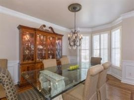 Lexington glass top dining room table.                                China cabinet is NOT FOR SALE