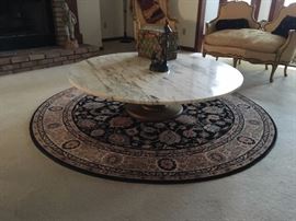 Marble top round coffee table and round Couristan rug underneath
