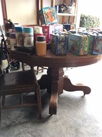 Very nice oak pedestal table with 4 chairs...Under the lunch boxes...