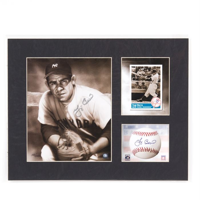 Yogi Berra Signed New York Yankees Lithograph: A Yogi Berra signed New York Yankees lithograph. It features an official MLB hologram-stamped image of Berra that has been hand signed by the player, an image of his baseball card, and an image of a baseball with a facsimile signature. All three are set in a black, partitioned matting and protected by a clear plastic sleeve. This piece is numbered 145/5000 and includes Toon Art Inc. and Classic Moments certificates of authenticity.