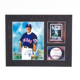 Rafael Palmeiro Signed Texas Rangers Lithograph: A Rafael Palmeiro signed Texas Rangers lithograph. It features an official MLB hologram-stamped image of Palmeiro that has been hand signed by the player, an image of his baseball card, and an image of a baseball with a facsimile signature. All three are set in a black, partitioned matting and protected by a clear plastic sleeve. This piece is numbered 25/5000 and includes Toon Art Inc. and Classic Moments certificates of authenticity.