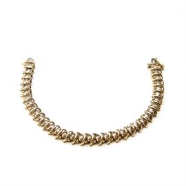14K Gold and Diamond Tennis Bracelet: A 14K gold and champagne colored diamond tennis bracelet with a locking clasp.
