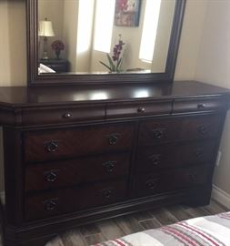 Spare Bedroom
Queen Sleigh Bed
Nighstands (2) w Convertible Top Drawer
Highboy (Jewelry Felt Lined and Cedar Lined Drawers) 
Dresser w Mirror (Jewelry Felt Lined and Cedar Lined Drawers) 
Urban Chenab One Bedding                                           (5 pc: Quilt, 2 Shams w Pillows) 
