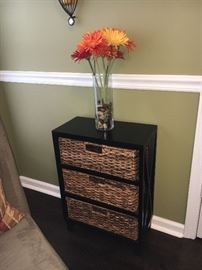 Bookcase with storage baskets, floral décor.