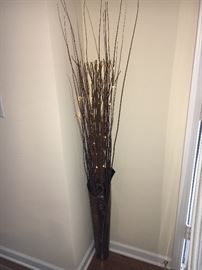 Assorted contemporary décor, vase with lighted twigs.