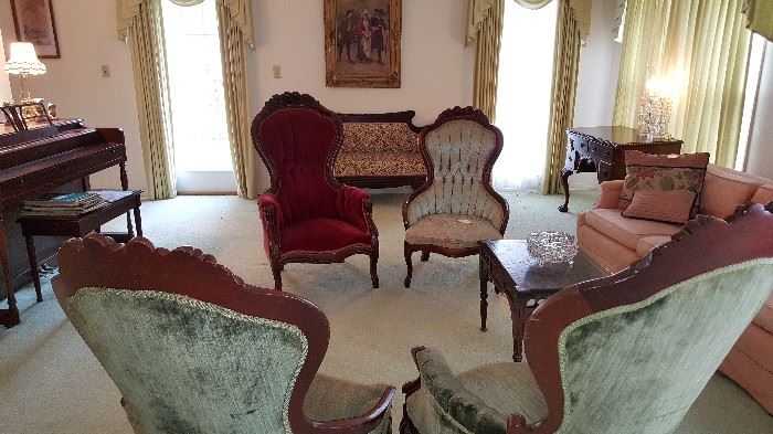 Broad view of living room showing mahogany chairs, 2 sofas, piano and more - very lovely.