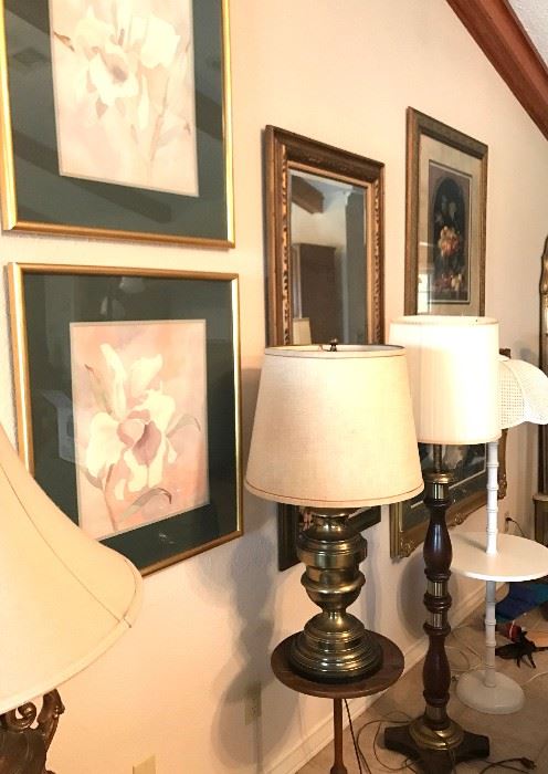 Framed pictures, beveled mirror, table and floor lamps, accent table.