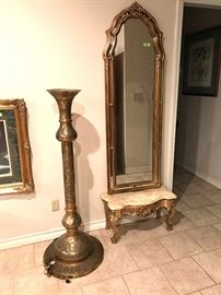 Tooled brass Moroccan uplight floor lamp. Tall wall mirror. Elegant marble top accent table with gilt legs.