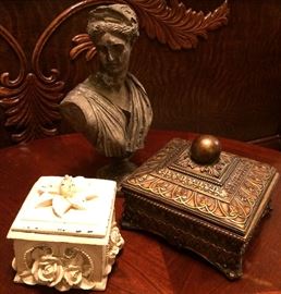 Lidded decorative boxes and vintage bust with weathered patina. 