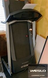Weslo Cadence electric treadmill, shown in its storage position.