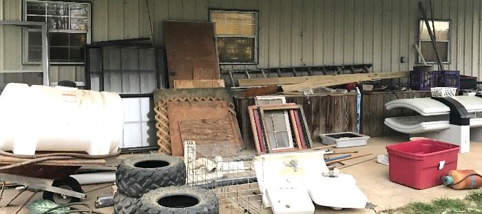 Windows, doors, lattice, water tank, tires, porcelain sinks, extension ladder, wheelbarrow, tanning bed, metal pet cage, assorted wood and 2 large wooden storage boxes crafted of old barn wood.
