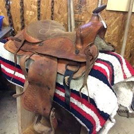 Vintage leather saddle - suitable for a child or for display. Woven blanket. Chains for towing. Wood box