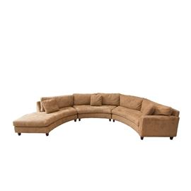 Havertys Sectional Microfiber Sofa: A Havertys sectional Microfiber sofa. It features three arched sections with removable back and seat cushions, and conical wooden feet. The section furthest to the left has an armrest, while that to the right serves as a chaise. The piece is covered with a brown microfiber upholstery.