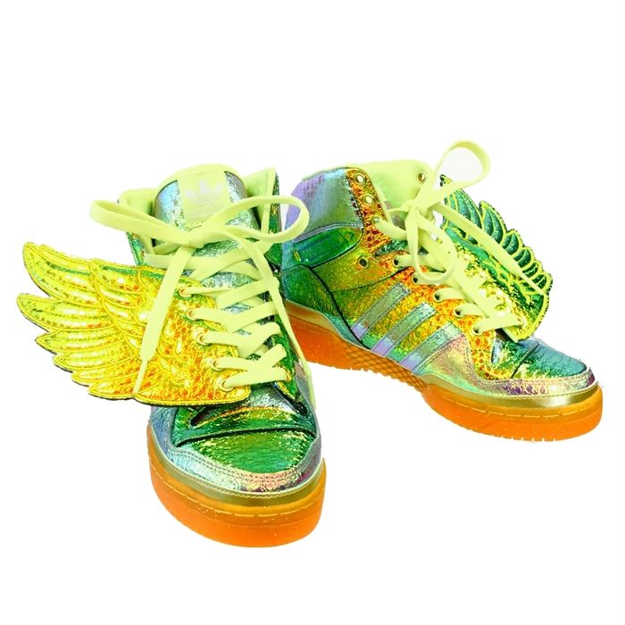 2014 Jeremy Scott Adidas Iridescent Gold Foil Wings Sneakers: A pair of 2014 Jeremy Scott for Adidas Iridescent Gold Foil Wings sneakers. This pair of Adidas sneakers from Jeremy Scott features a metallic gold tone foil wing design. The hi-top sneakers have an iridescent gold, purple, green, blue and orange design with white laces.