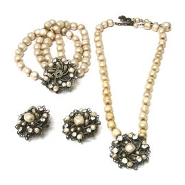 1940s DeMario N.Y. Rhinestone & Faux Pearl Parure: A 1940s DeMario New York parure. This selection features a matching jewelry set that includes a pair of clip-on earrings, a necklace, and a bracelet. Each piece features foliate metalwork with faux pearls and rhinestones. They are stamped by DeMario N.Y.