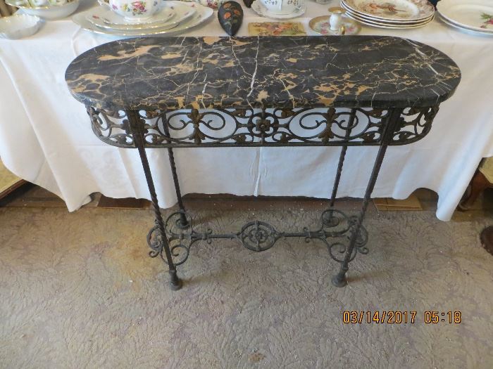 This Vintage marble top resting on a pierced painted iron base. "SOLD" on line prior to the two day Sale.