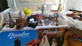 Lord of the Rings goblet, Firina, cowbell, Bruce Sutter glove, canon ae1 camera, Christian Bros brandy wine bottle and stand, golf clock, polished rocks, geode, viking invasion goblet, posters