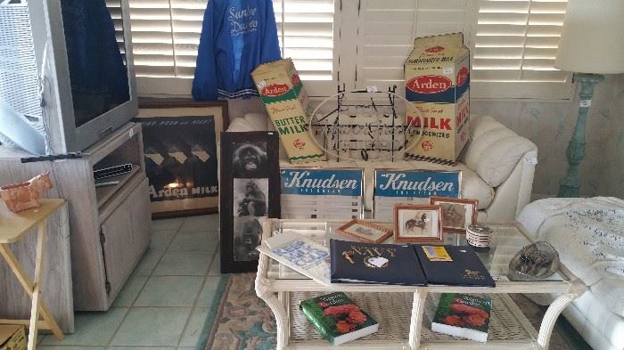 Arden, Knudsen metal signs, coffee table, Santee dairies jacket, Arden farms framed art, Navy book, horse art, leather couch, loveseat