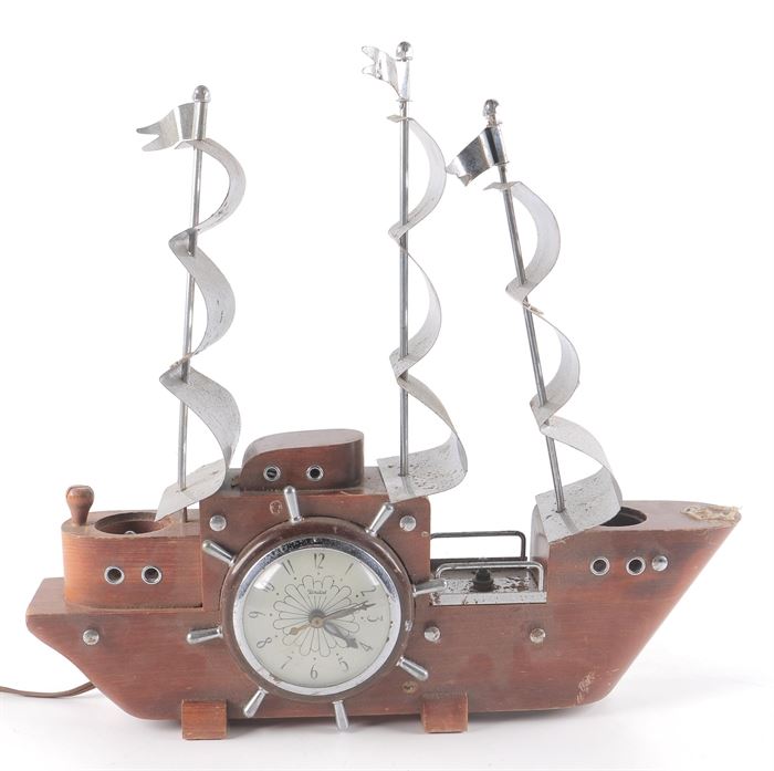 Ship Clock Lamp: A ship desk lamp clock. It features a cherry wood base and metal sails. This lamp powered on when tested.