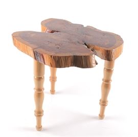 Wood Slab Side Table: A wood slab side table. This three legged table features a stained and lacquered natural wood slab top.